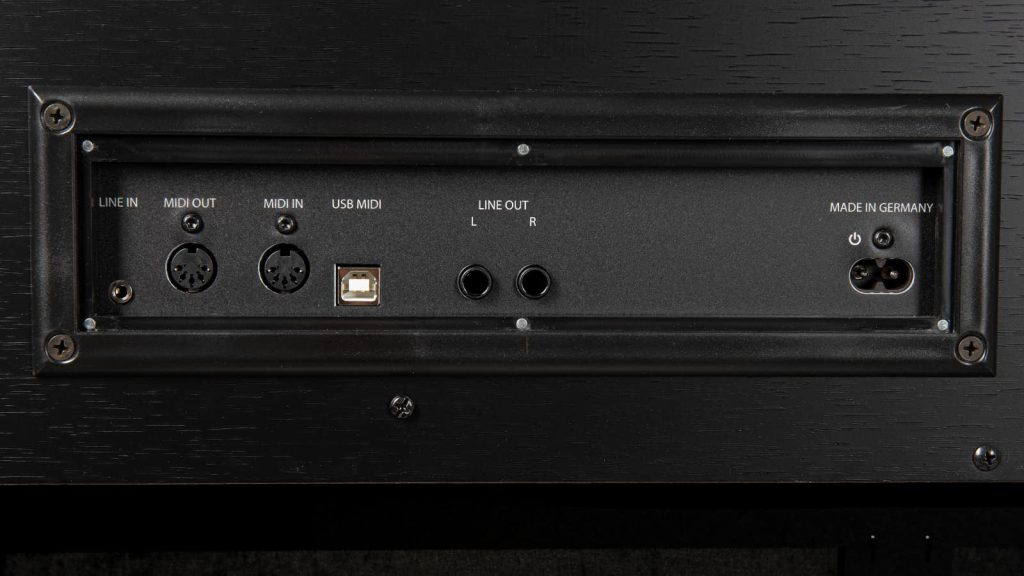 Most of the connections are located on the rear panel, including USB-MIDI, audio outputs, MIDI In/Out, and the power supply input. The headphone jacks and a USB-to-device port are conveniently positioned on the left side beneath the keyboard. (Image Source: GEWA)